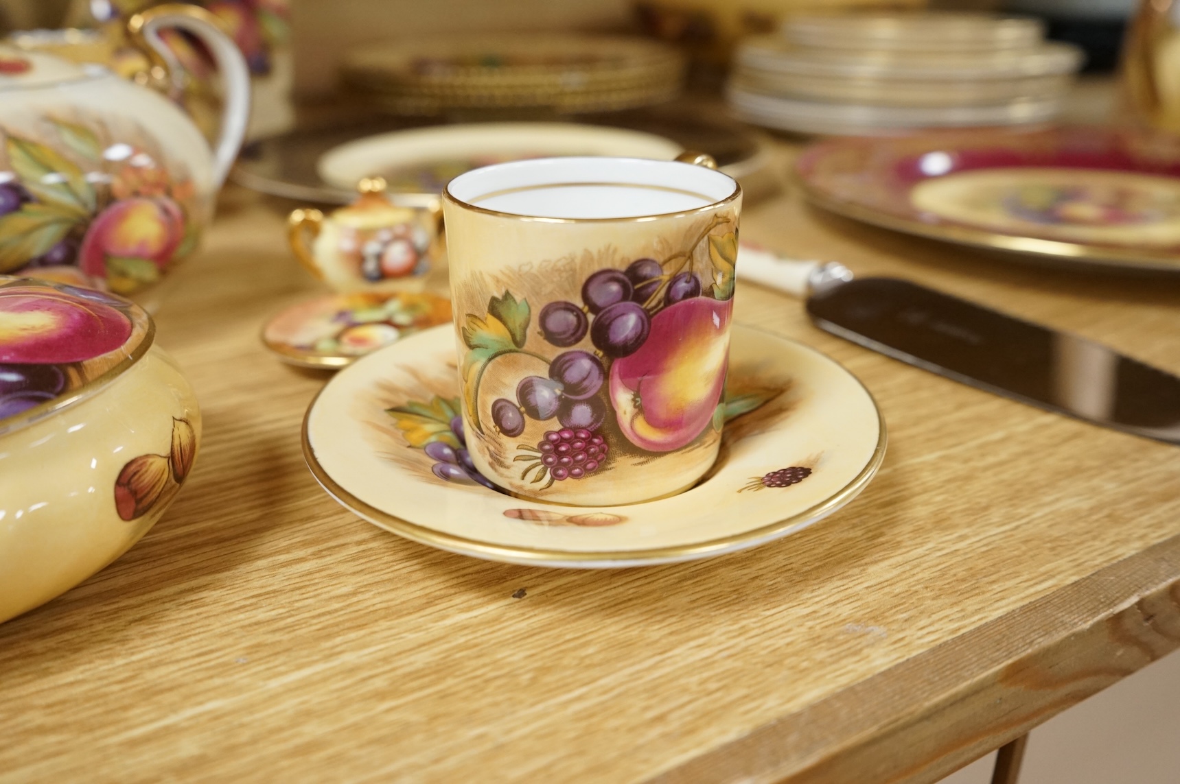 A collection of Aynsley ‘Orchard Gold’ fruit-painted tea/dinner wares and vases, largely signed by D Jones, largest 26cm in diameter